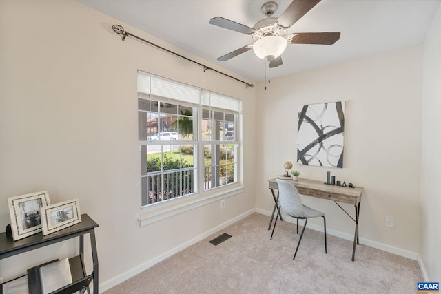 carpeted office with baseboards, a ceiling fan, and visible vents