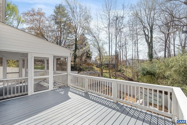 wooden deck with a sunroom