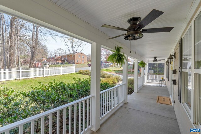 view of patio / terrace featuring a porch, ceiling fan, and fence
