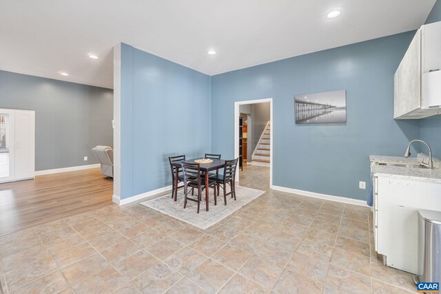 dining room with stairs, baseboards, and recessed lighting