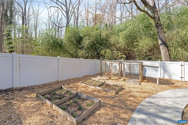 view of yard with a vegetable garden and a fenced backyard