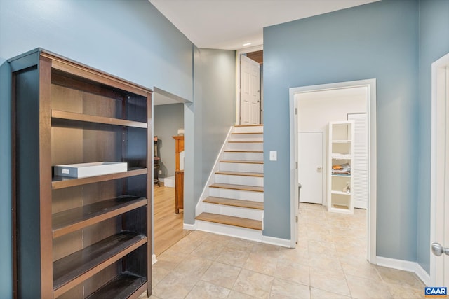 staircase with baseboards, tile patterned flooring, and recessed lighting