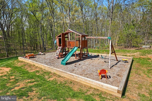 view of playground featuring a wooded view