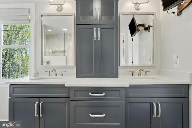 full bath with healthy amount of natural light and double vanity