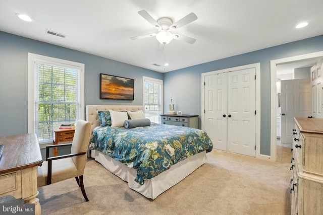 bedroom featuring light carpet, multiple windows, a closet, a ceiling fan, and recessed lighting