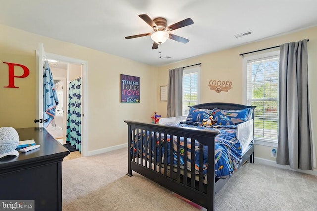 carpeted bedroom with multiple windows, baseboards, and ceiling fan