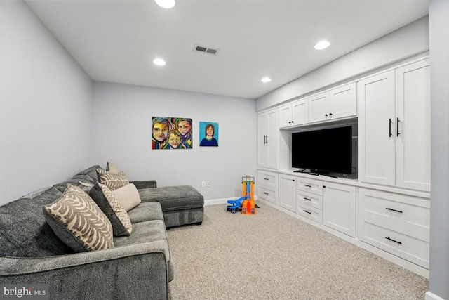 carpeted living area with recessed lighting and baseboards