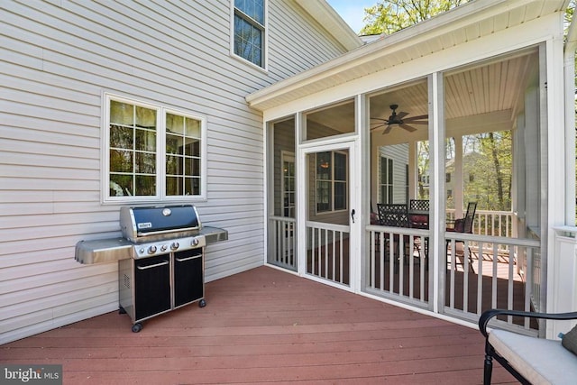 wooden terrace with a grill and a sunroom