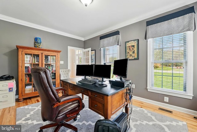 office space featuring crown molding, wood finished floors, and baseboards