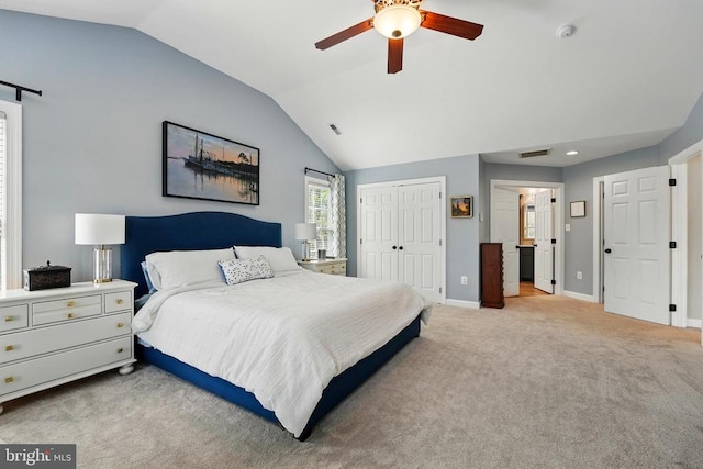 carpeted bedroom featuring vaulted ceiling, baseboards, a closet, and ceiling fan