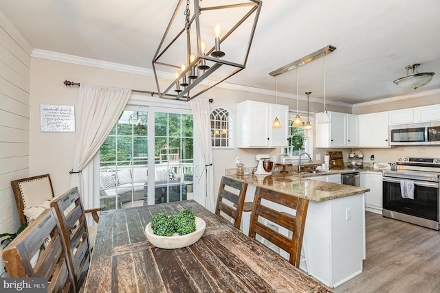 4511 Cornwall Ct, Fredericksburg, VA 22408 - kitchen with stainless steel appliances, crown molding, light stone counters, white cabinetry, and a peninsula