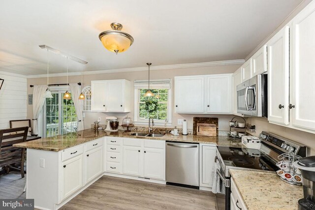 4511 Cornwall Ct, Fredericksburg, VA 22408 - kitchen with stainless steel appliances, a peninsula, white cabinets, light stone countertops, and crown molding