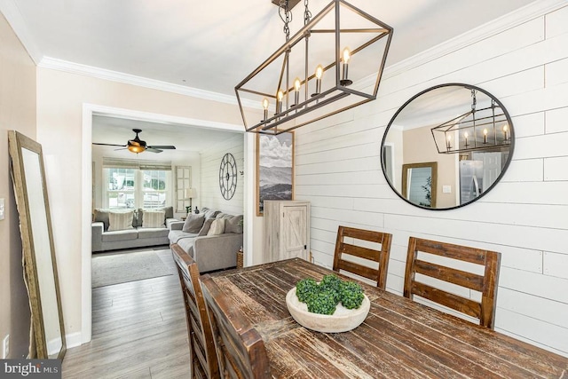 4511 Cornwall Ct, Fredericksburg, VA 22408 - dining room featuring wood finished floors, a chandelier, crown molding, wooden walls, and ceiling fan