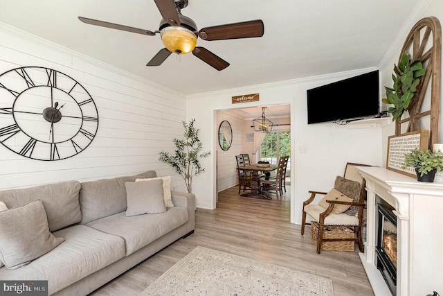 4511 Cornwall Ct, Fredericksburg, VA 22408 - living room with ornamental molding, light wood-type flooring, ceiling fan, a chandelier, and a glass covered fireplace