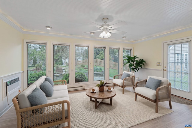 sunroom / solarium with a healthy amount of sunlight, ornamental molding, and baseboard heating