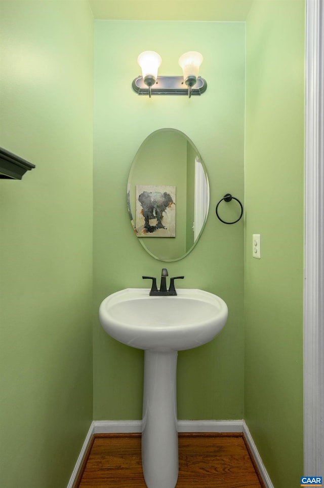 bathroom with baseboards and wood finished floors