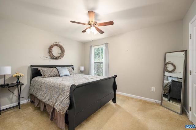 bedroom featuring baseboards, light carpet, and a ceiling fan