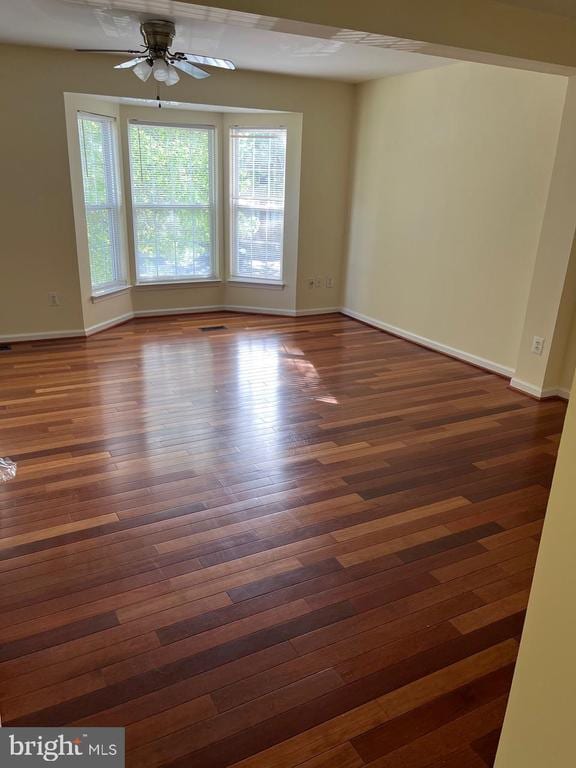 9808 Bartley Ct, Fredericksburg, VA 22408 - spare room with dark wood-style floors, ceiling fan, and baseboards