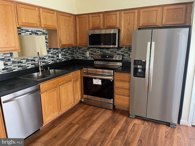 9808 Bartley Ct, Fredericksburg, VA 22408 - kitchen featuring appliances with stainless steel finishes, a sink, dark countertops, and backsplash