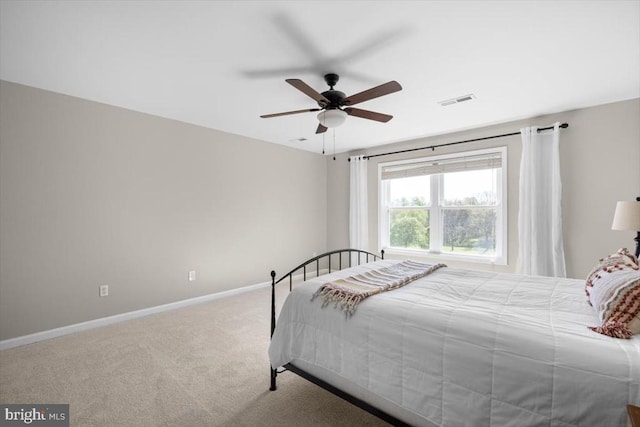 carpeted bedroom featuring baseboards and a ceiling fan
