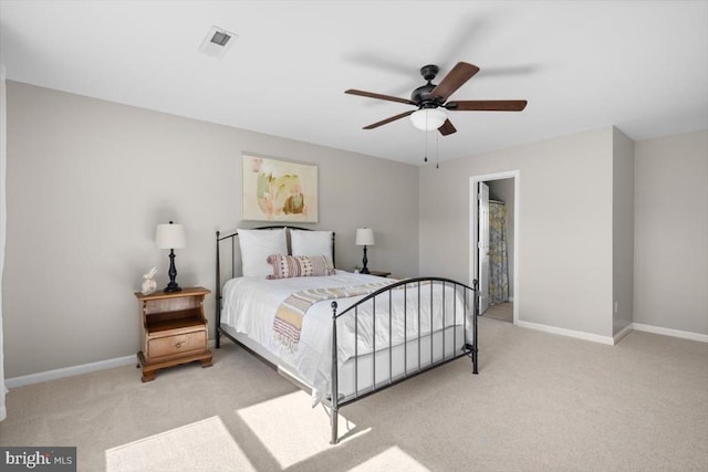bedroom with light colored carpet, baseboards, and ceiling fan