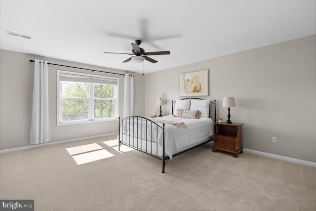 carpeted bedroom with baseboards and a ceiling fan