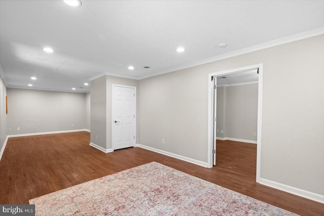 basement with crown molding, wood finished floors, baseboards, and recessed lighting
