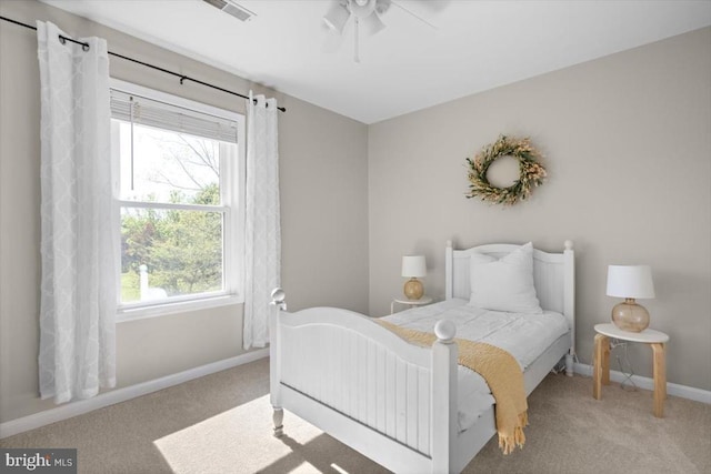 carpeted bedroom with multiple windows, baseboards, and ceiling fan