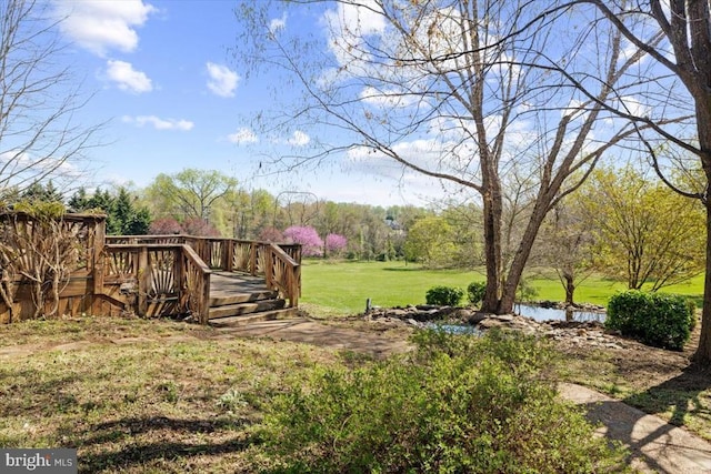 view of grassy yard featuring a deck