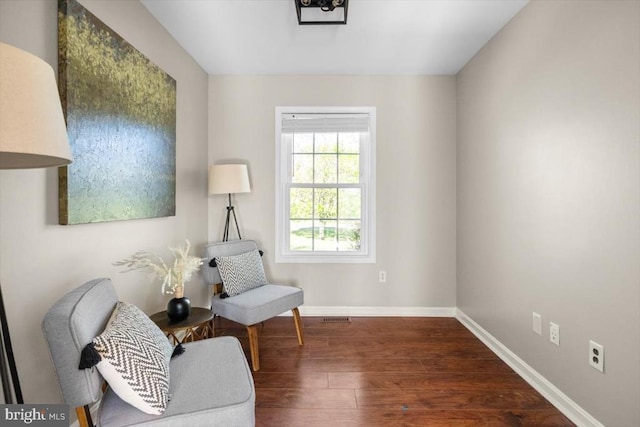sitting room with baseboards and wood finished floors
