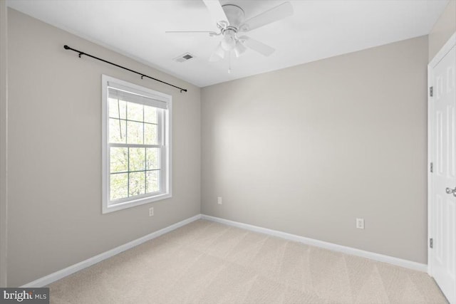 empty room with light carpet, baseboards, and ceiling fan