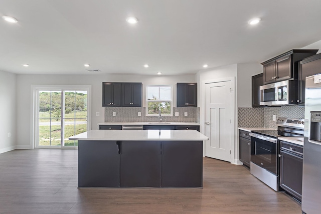 3665 Mayfield Rd, Rockingham, VA 22801 - kitchen featuring stainless steel appliances, light countertops, a center island, a sink, and backsplash