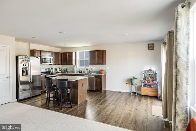 2612 High Pt, Culpeper, VA 22701 - kitchen with appliances with stainless steel finishes, dark wood-style floors, a center island, a kitchen bar, and dark brown cabinetry