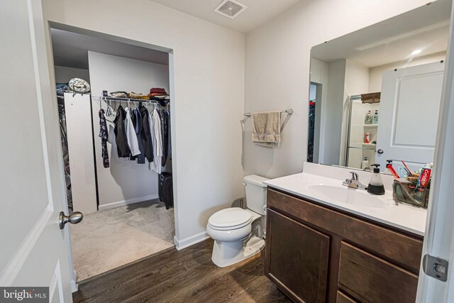 2612 High Pt, Culpeper, VA 22701 - bathroom with wood finished floors, vanity, a spacious closet, and toilet