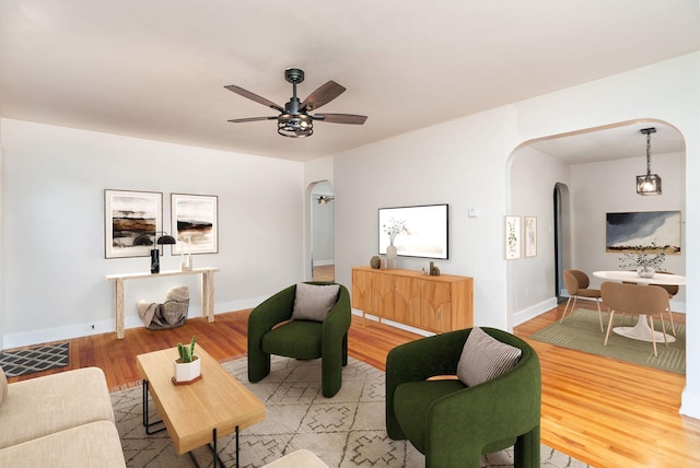 123 Fraser Ln, Staunton, VA 24401 - living area featuring arched walkways, light wood finished floors, ceiling fan, and baseboards