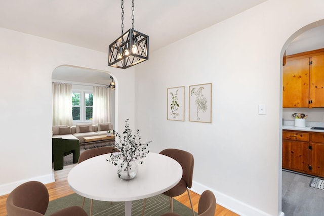 123 Fraser Ln, Staunton, VA 24401 - dining area with arched walkways, light wood finished floors, and baseboards