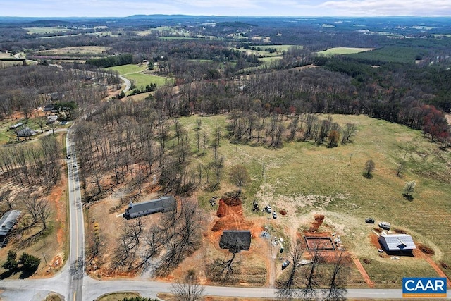 birds eye view of property featuring a view of trees