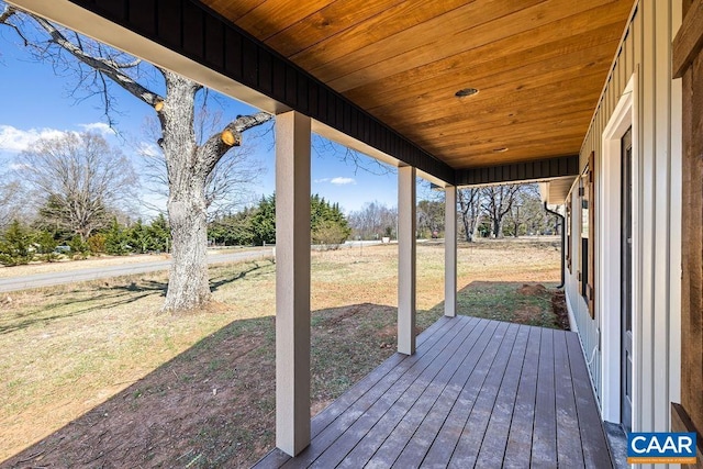 wooden terrace with a yard