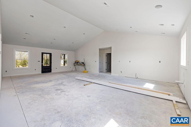 unfurnished living room with lofted ceiling