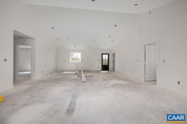 unfurnished living room with visible vents and high vaulted ceiling