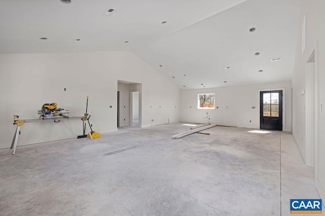 unfurnished living room featuring vaulted ceiling