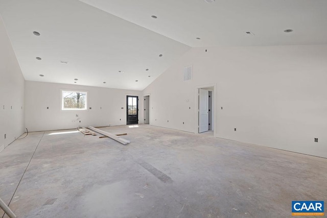 unfurnished living room featuring visible vents, concrete flooring, and high vaulted ceiling
