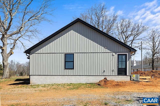 view of side of property featuring cooling unit and board and batten siding