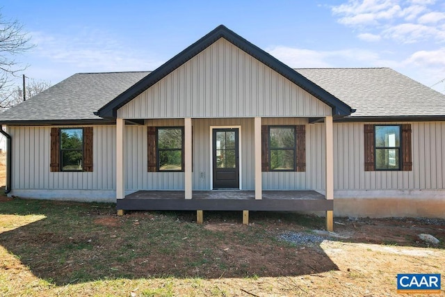 exterior space featuring covered porch, roof with shingles, and board and batten siding
