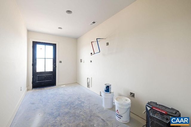 interior space with concrete floors, baseboards, and visible vents