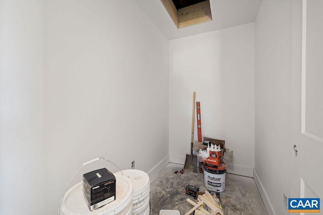 misc room featuring concrete floors and baseboards