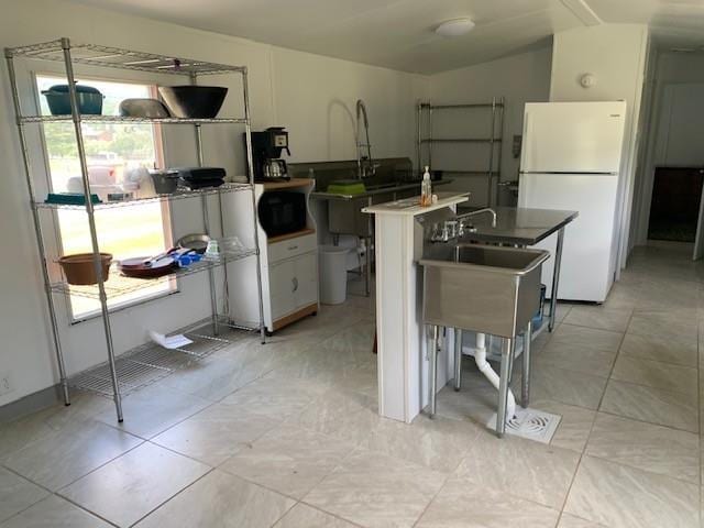 303 Myers-Moon Rd, Monterey, VA 24465 - kitchen featuring freestanding refrigerator, white cabinetry, a center island, and light tile patterned flooring