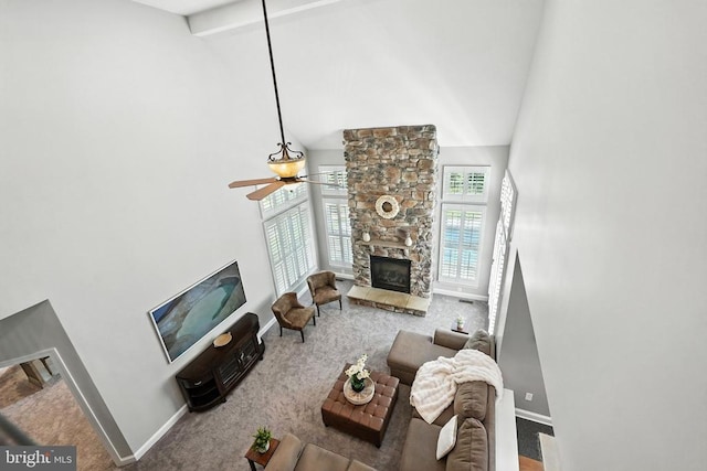11220 Chivalry Chase Ln, Spotsylvania, VA 22551 - living room featuring high vaulted ceiling, carpet, a stone fireplace, a ceiling fan, and beamed ceiling