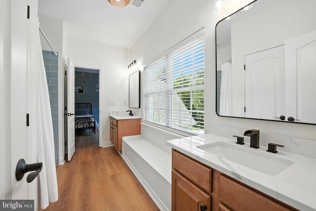 11220 Chivalry Chase Ln, Spotsylvania, VA 22551 - bathroom with wood finished floors, vanity, and a shower with curtain