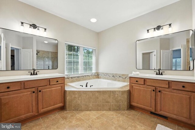 11220 Chivalry Chase Ln, Spotsylvania, VA 22551 - bathroom featuring a stall shower, two vanities, and a bath